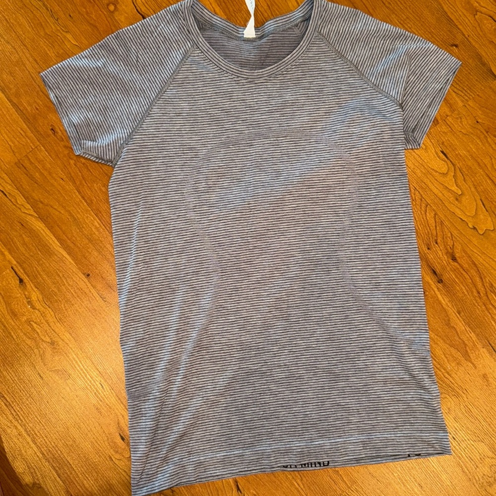 Worn once, like new. Women’s lululemon size 10 swiftly tech short sleeve.